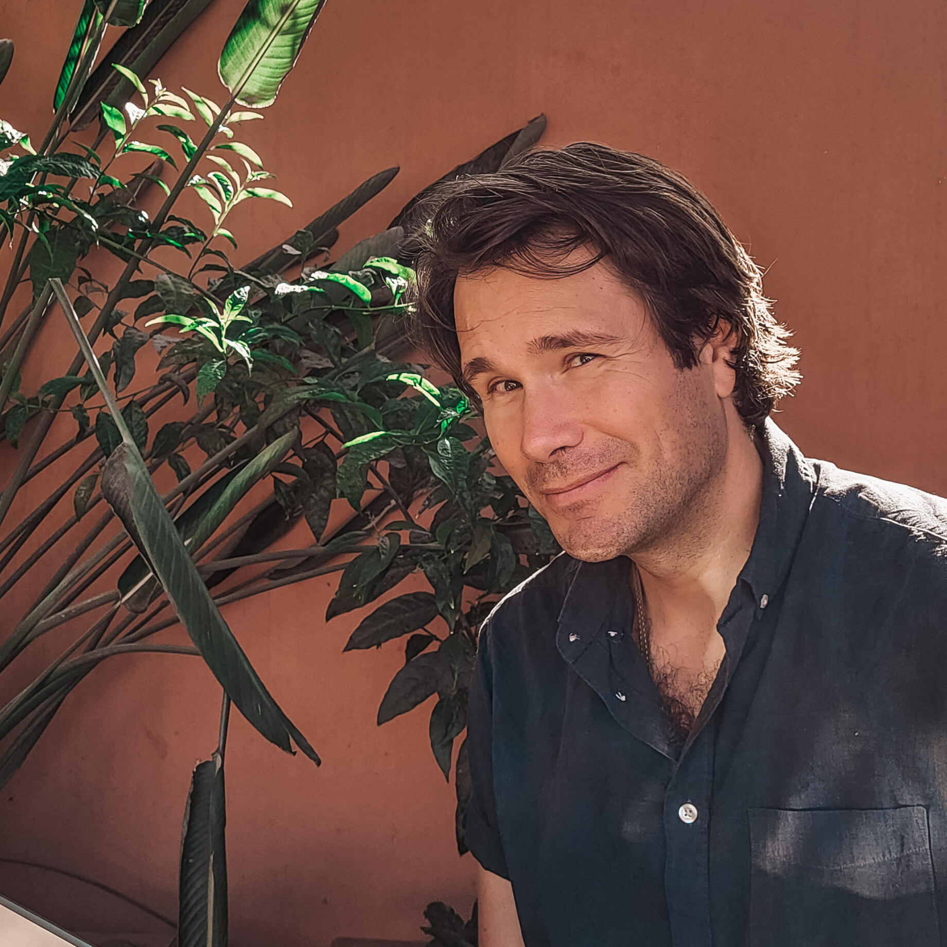 Man with brown hair looking into camera smiling